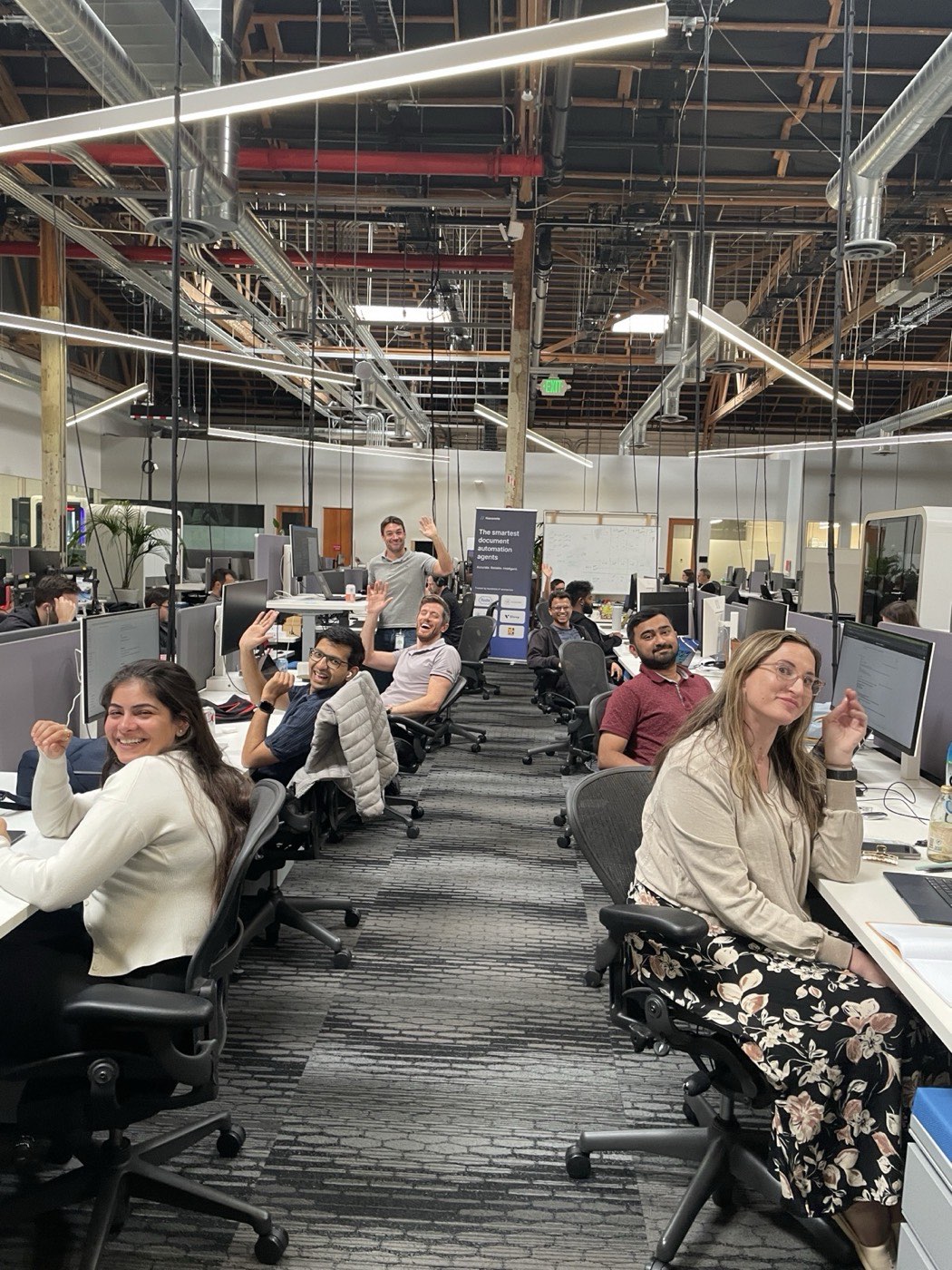 The Palo Alto office floor, team waving from their desks